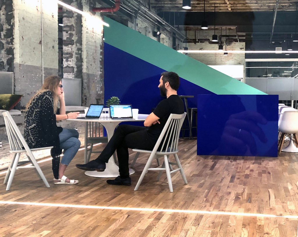Kara and Chris sitting in Helpful's office in New York City