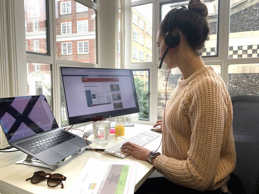 Helpful staff member working on crisis simulation from her desk